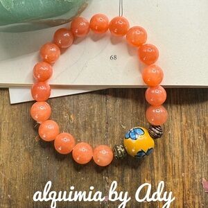 Orange Beaded Bracelet with Decorative Bead